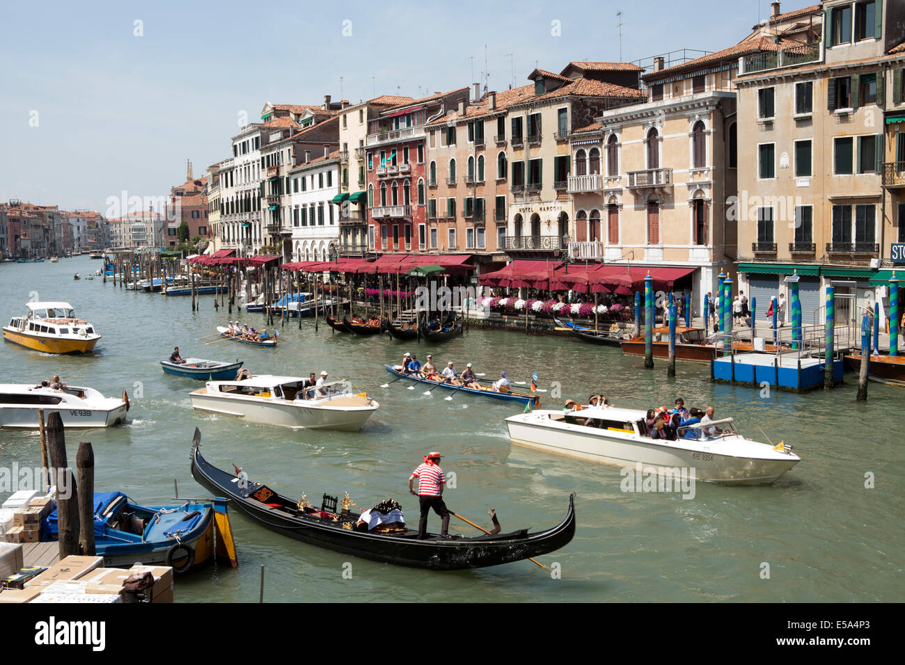 Gondolas and tourist boats wait to navigate the overcrowded Grand Canal, Venice Stock Photo