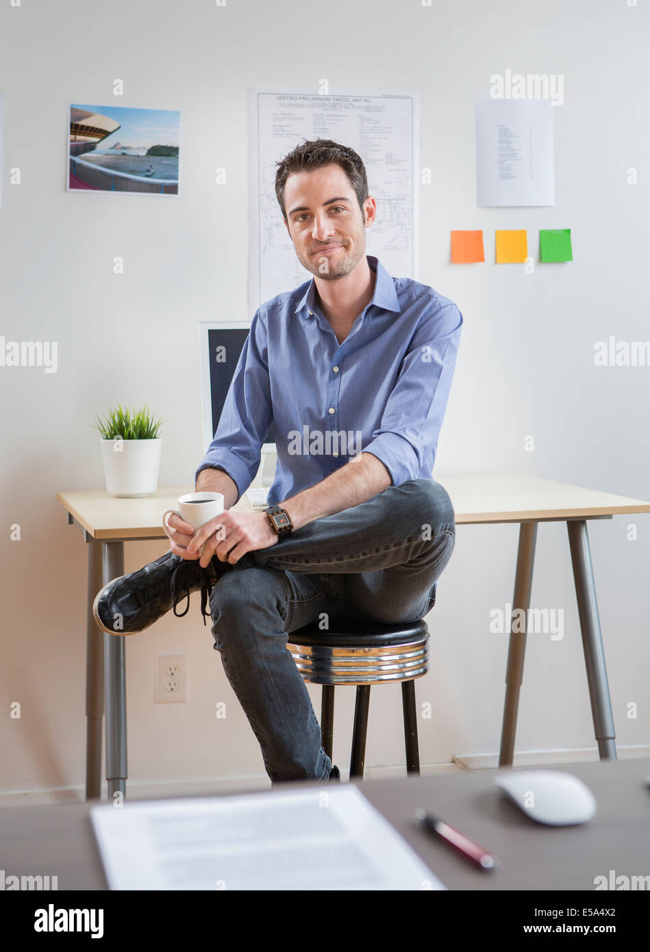 Caucasian architect drinking coffee in office Stock Photo Alamy