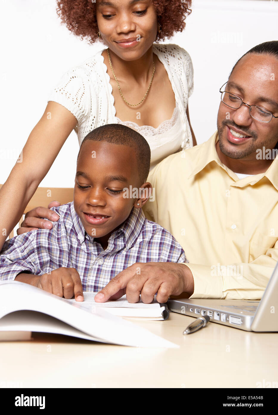 African American parents helping son with homework Stock Photo