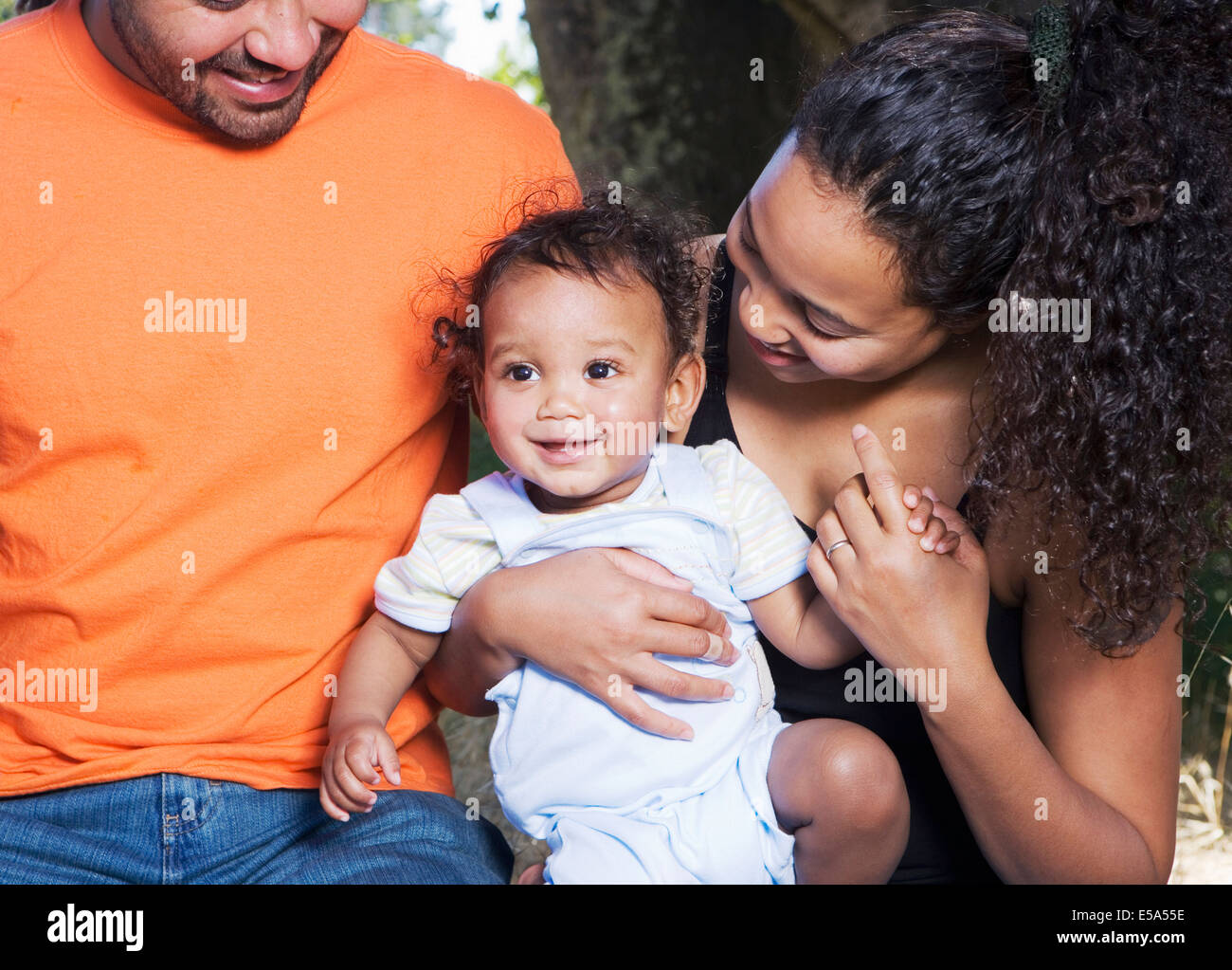 Couple holding baby outdoors Stock Photo