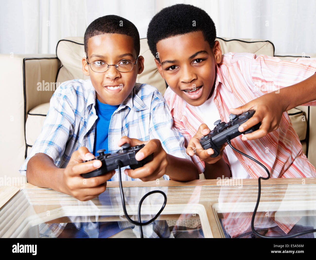 Mixed race boys playing video games Stock Photo