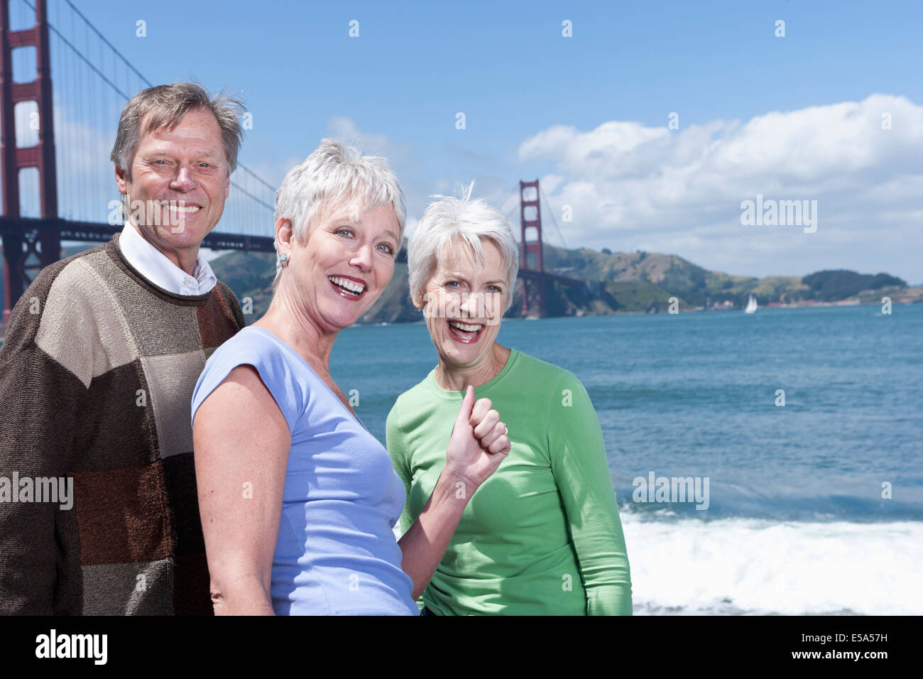 Senior Caucasian friends smiling by Golden Gate Bridge, San Francisco, California, United States Stock Photo