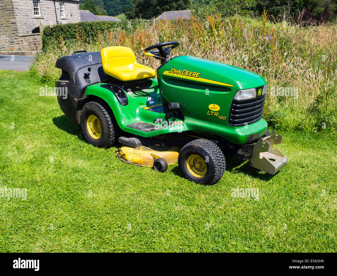 A John Deere LTR180 grass mower with an integral grass collector. Stock Photo