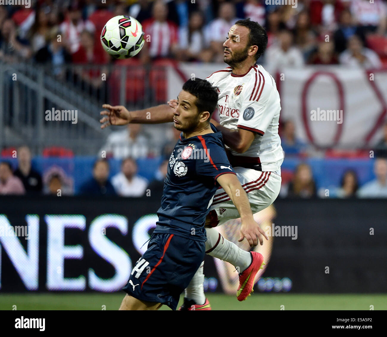 Toronto, Canada. 24th July, 2014. Guinness International Champions Cup. AC Milan v Olympiakos. Andreas Samaris pressed by Giampaolo Pazzini Credit:  Action Plus Sports Images/Alamy Live News Stock Photo