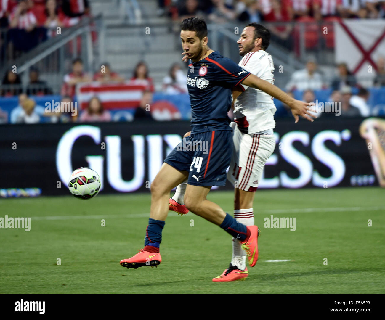 Toronto, Canada. 24th July, 2014. Guinness International Champions Cup. AC Milan v Olympiakos. Andreas Samaris pressed by Giampaolo Pazzini Credit:  Action Plus Sports Images/Alamy Live News Stock Photo