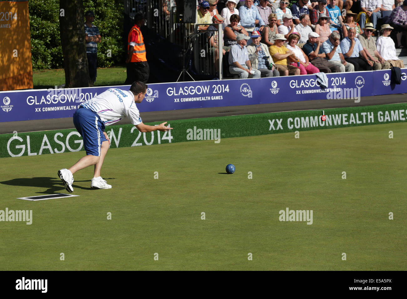Kelvingrove Lawn Bowls Centre, Glasgow, Scotland, UK, Friday, 25th  July, 2014. Neil Speirs of Scotland playing in a Men's Triples Lawn Bowls Preliminary Match at the Glasgow 2014 Commonwealth Games Stock Photo