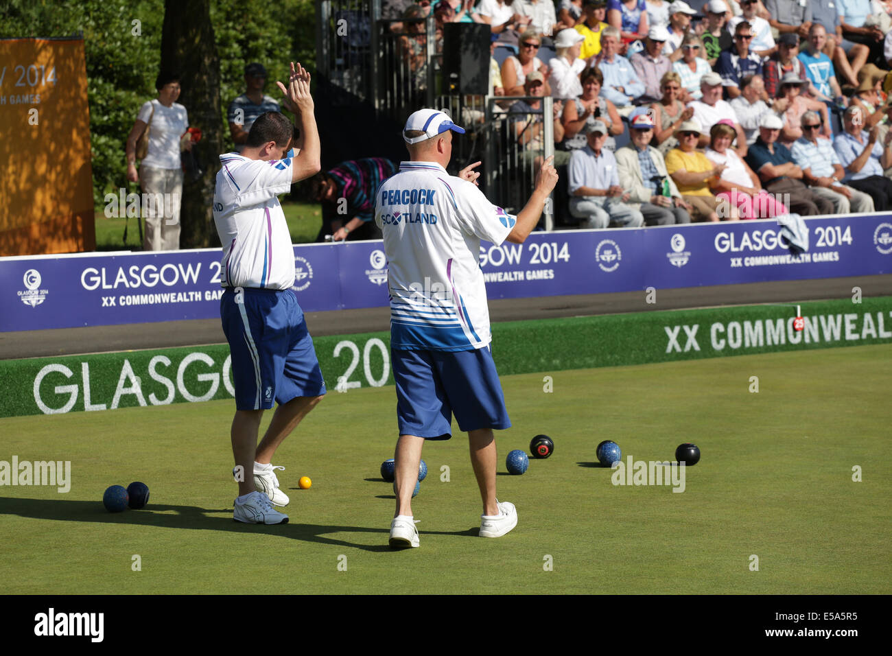 Kelvingrove Lawn Bowls Centre, Glasgow, Scotland, UK, Friday, 25th  July, 2014. Neil Speirs left and David Peacock right of Scotland playing in a Men's Triples Lawn Bowls Preliminary Match at the Glasgow 2014 Commonwealth Games Stock Photo