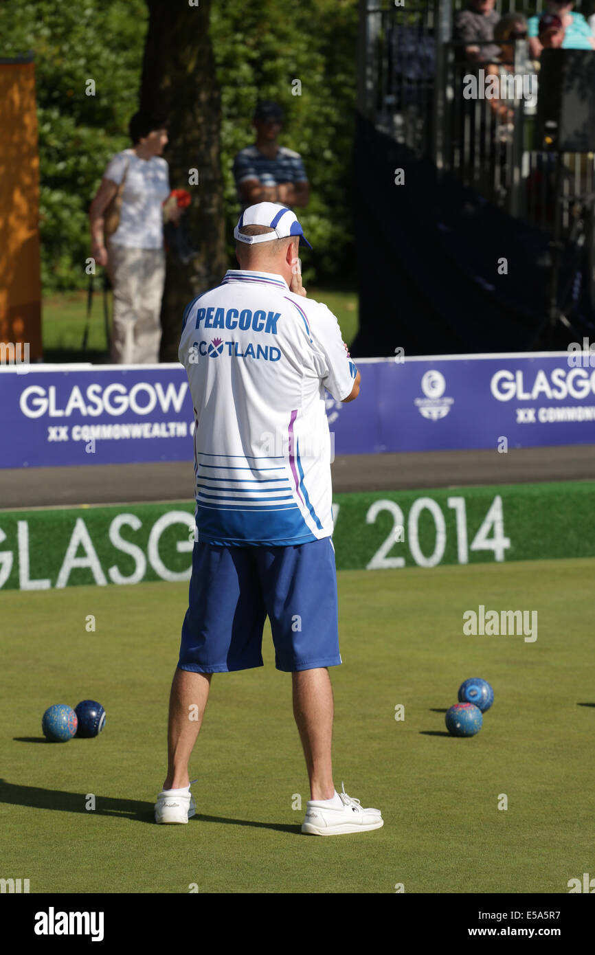 Kelvingrove Lawn Bowls Centre, Glasgow, Scotland, UK, Friday, 25th  July, 2014. David Peacock of Scotland playing in a Men's Triples Lawn Bowls Preliminary Match at the Glasgow 2014 Commonwealth Games Stock Photo