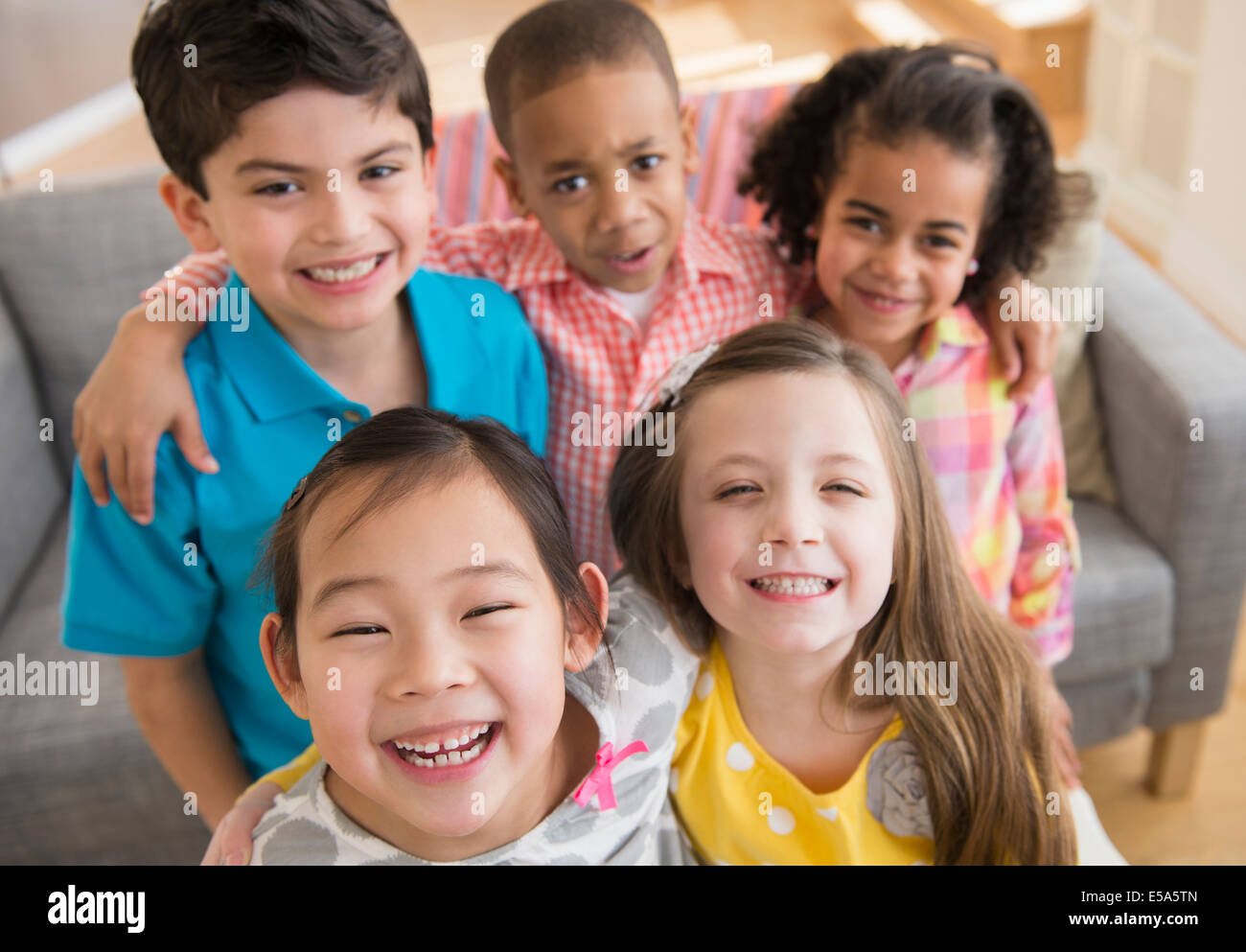 Children smiling together in living room Stock Photo - Alamy