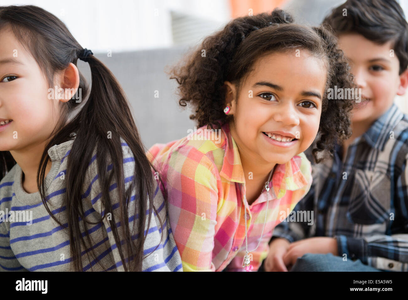 Children smiling in living room Stock Photo - Alamy