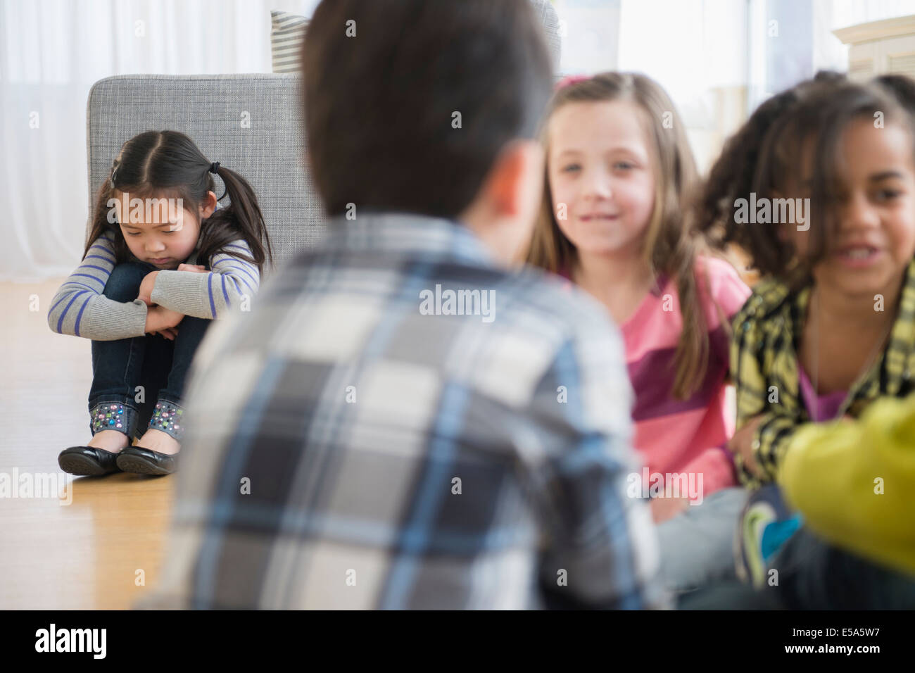 Children excluding girl in group Stock Photo