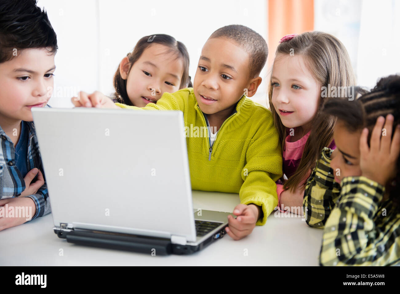 Children using laptop together Stock Photo