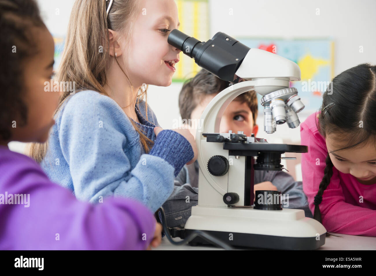 Students using microscope in classroom Stock Photo Alamy