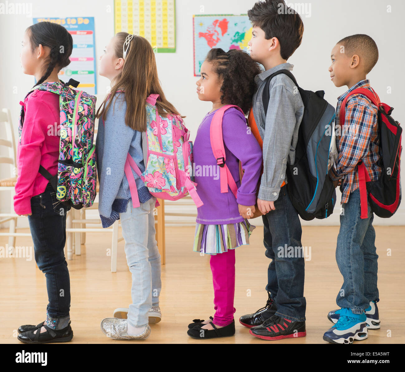Students standing in line in classroom Stock Photo