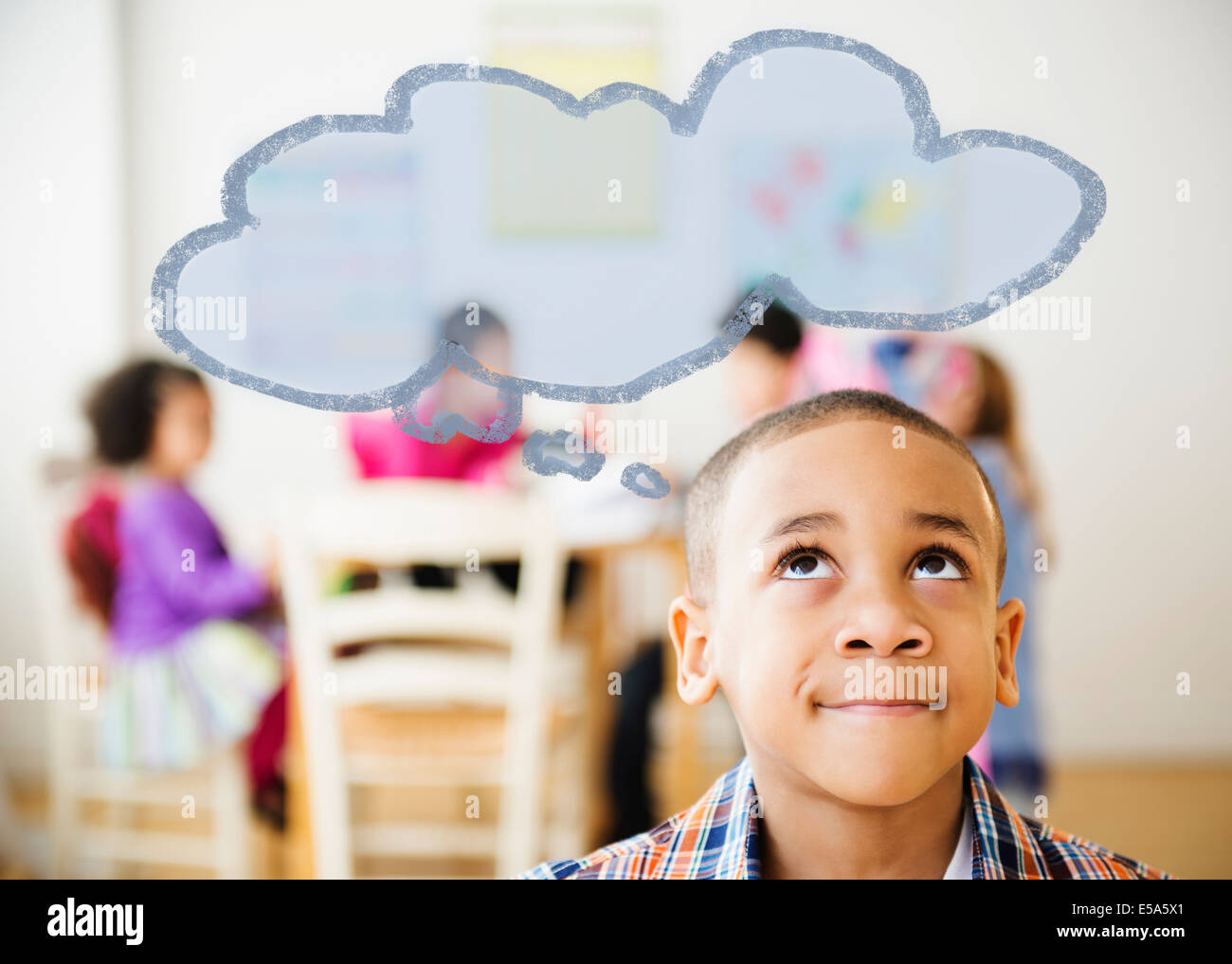 Boy with thought bubble over his head Stock Photo