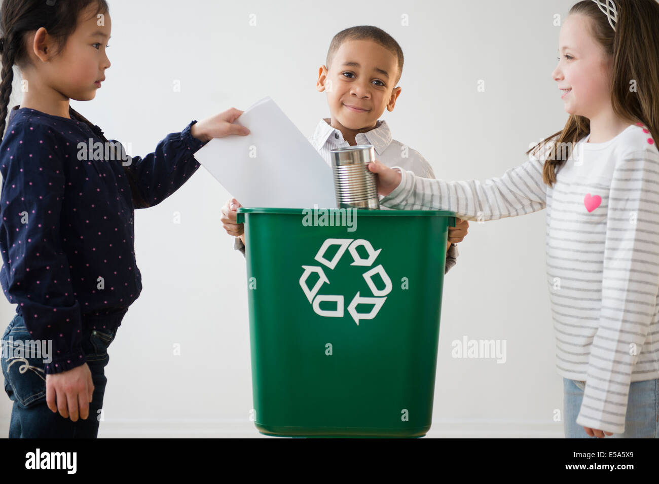 Children recycling together Stock Photo