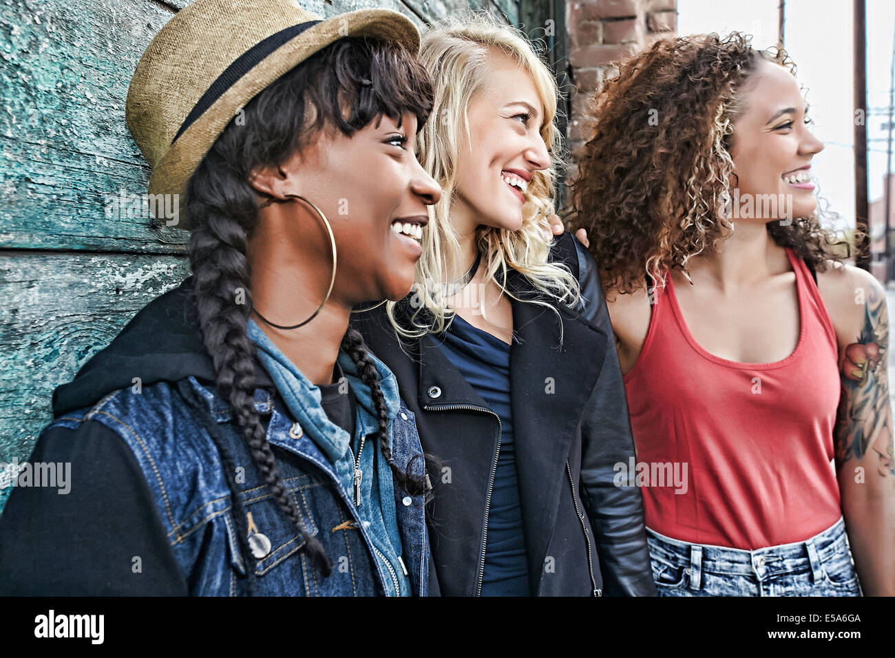 Women smiling together on city street Stock Photo - Alamy