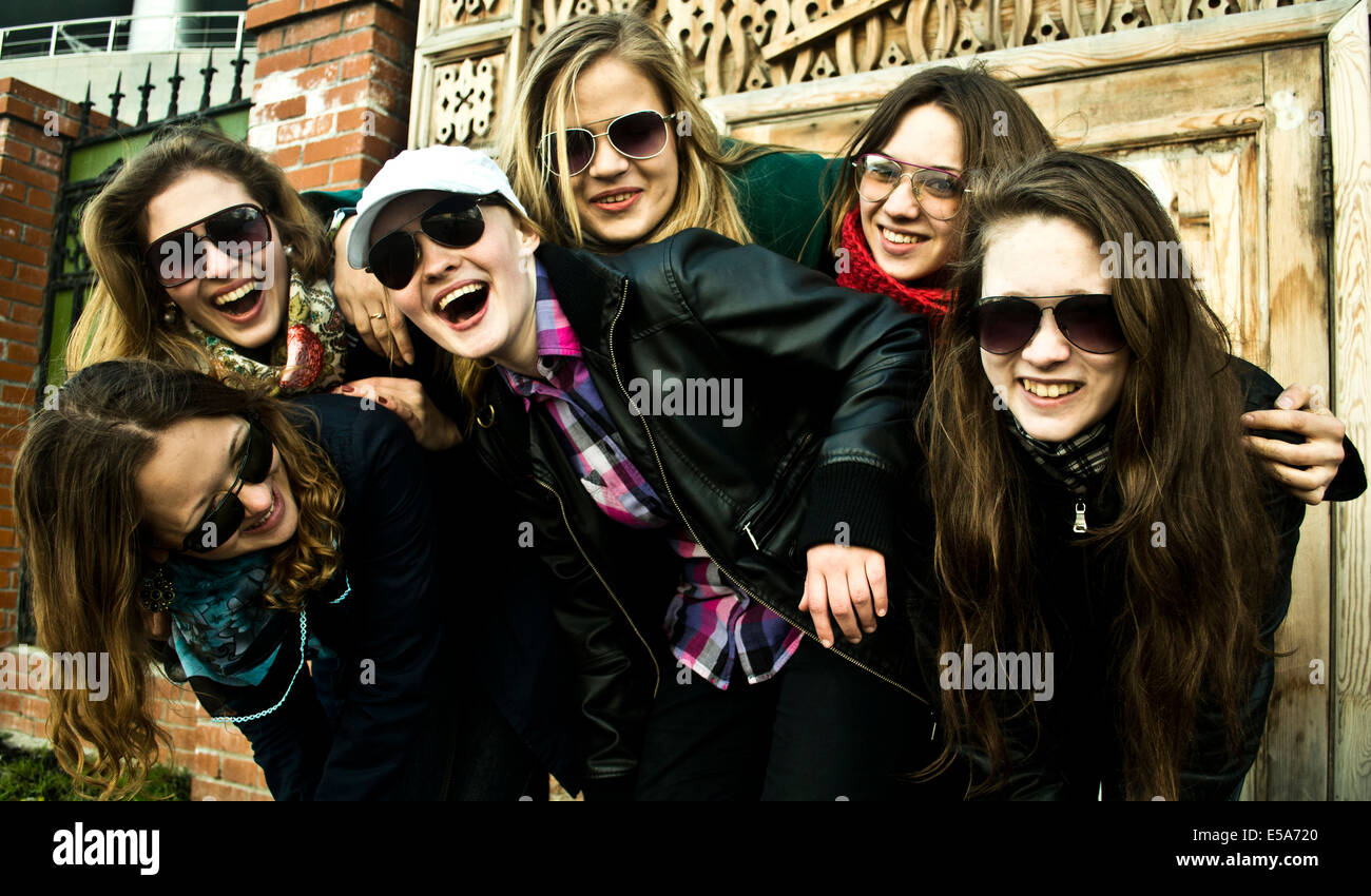 Women laughing together on city street Stock Photo - Alamy