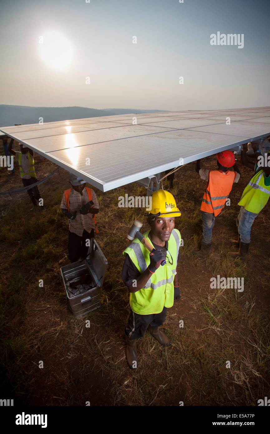 Technicians installing panels in one of East Africa's largest Solar farms, Rwamagana District, Rwanda. Stock Photo