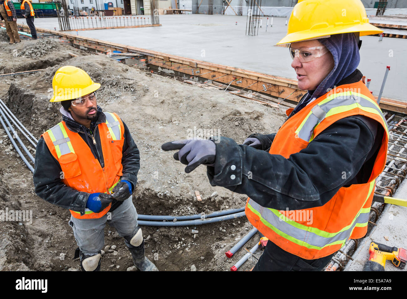 Workers talking at construction site Stock Photo