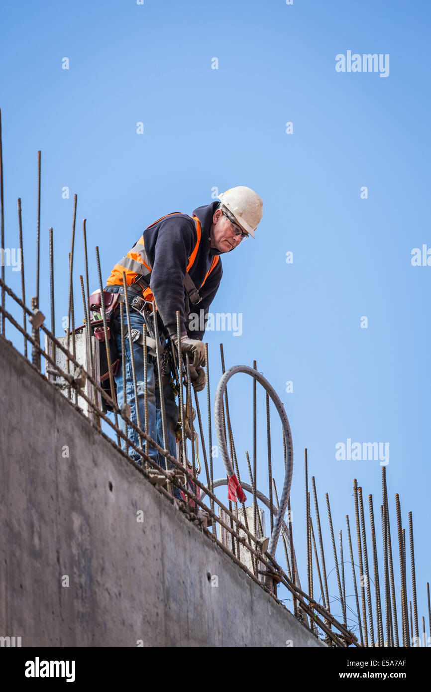 Caucasian worker on top of building Stock Photo