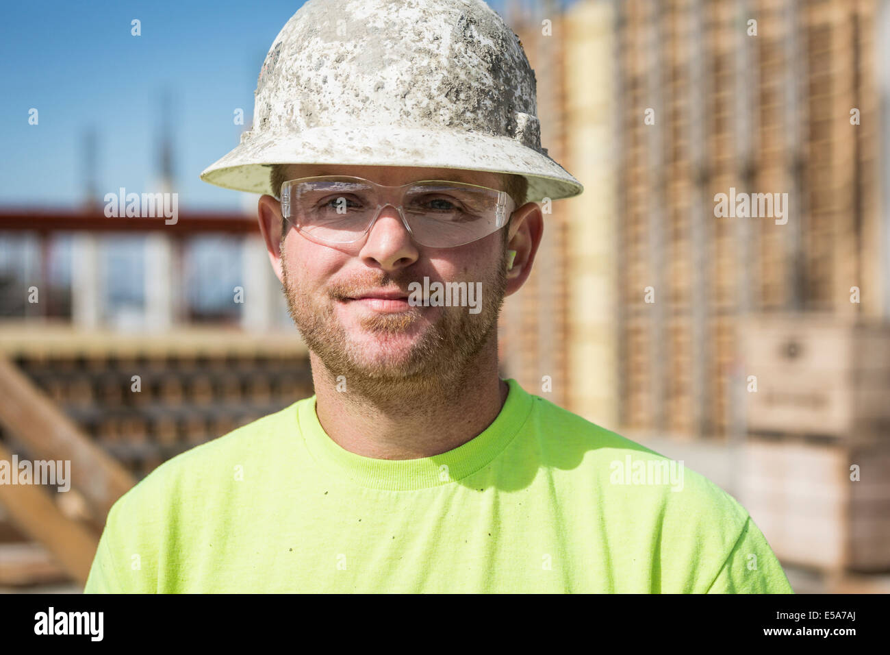 Worker smiling on construction site Stock Photo