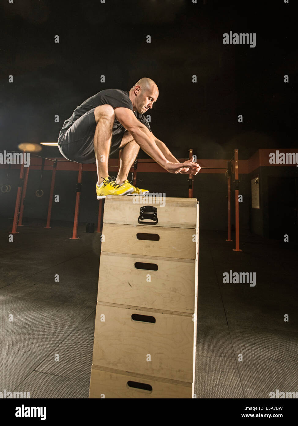 Caucasian man exercising in gym Stock Photo