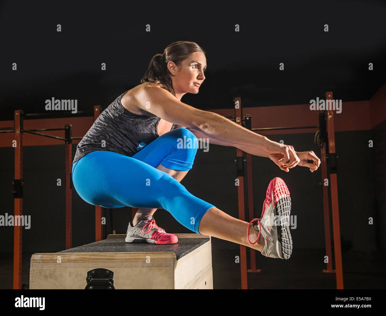 Caucasian woman exercising in gym Stock Photo