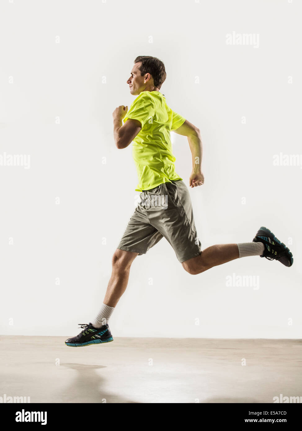 Caucasian man jogging indoors Stock Photo
