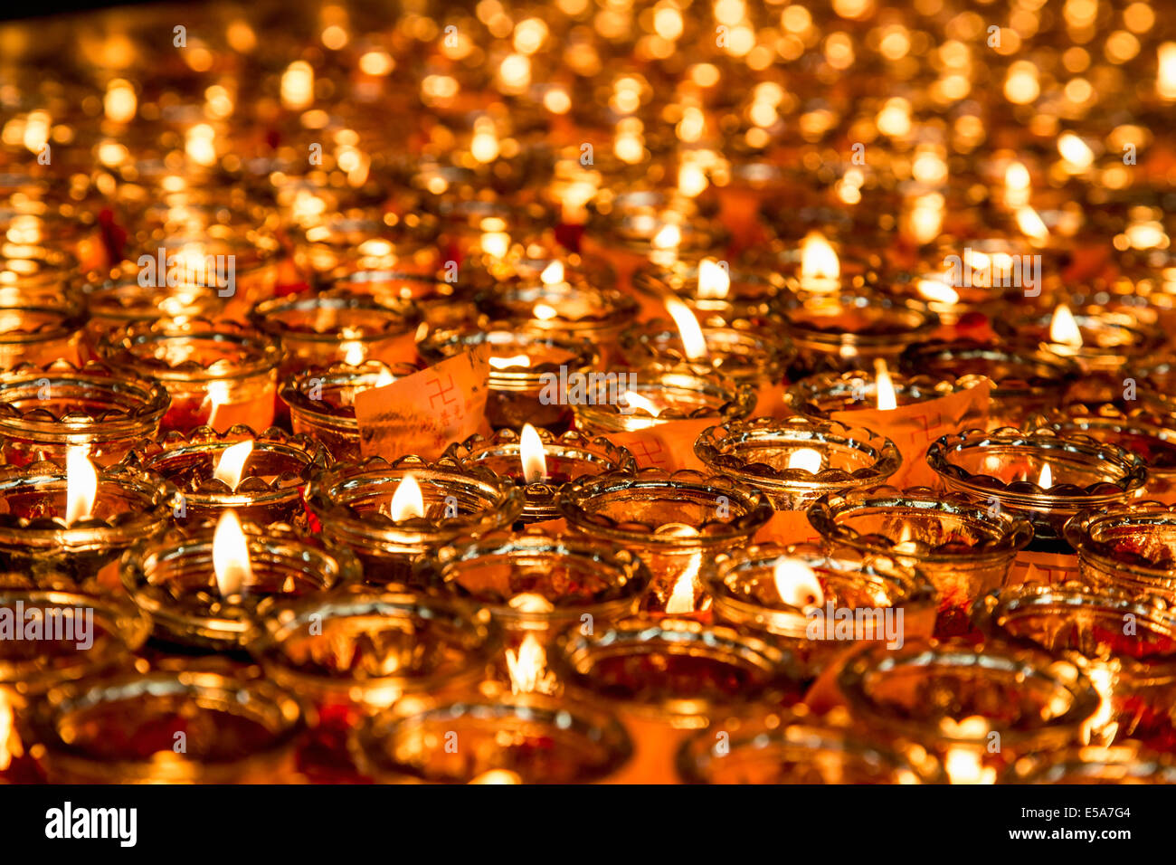 Close up of lit candles with wish notes Stock Photo Alamy