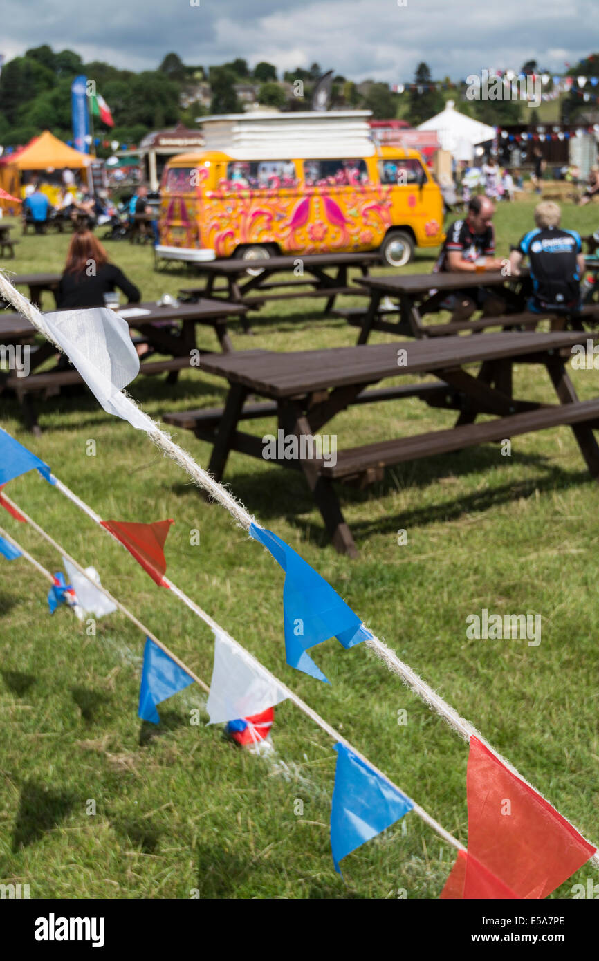 Brightly colored/painted VW camper van in field during show Bakewell Derbyshire England Stock Photo