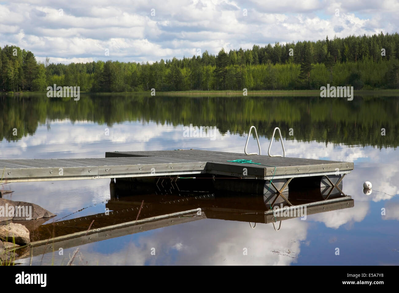 Lake scenery with a pier in summer in Finland Stock Photo