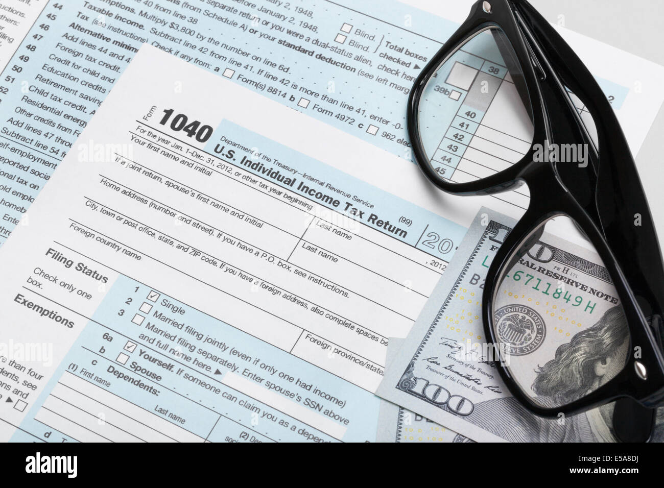 USA Tax Form 1040 with glasses and 100 US dollar bills Stock Photo - Alamy