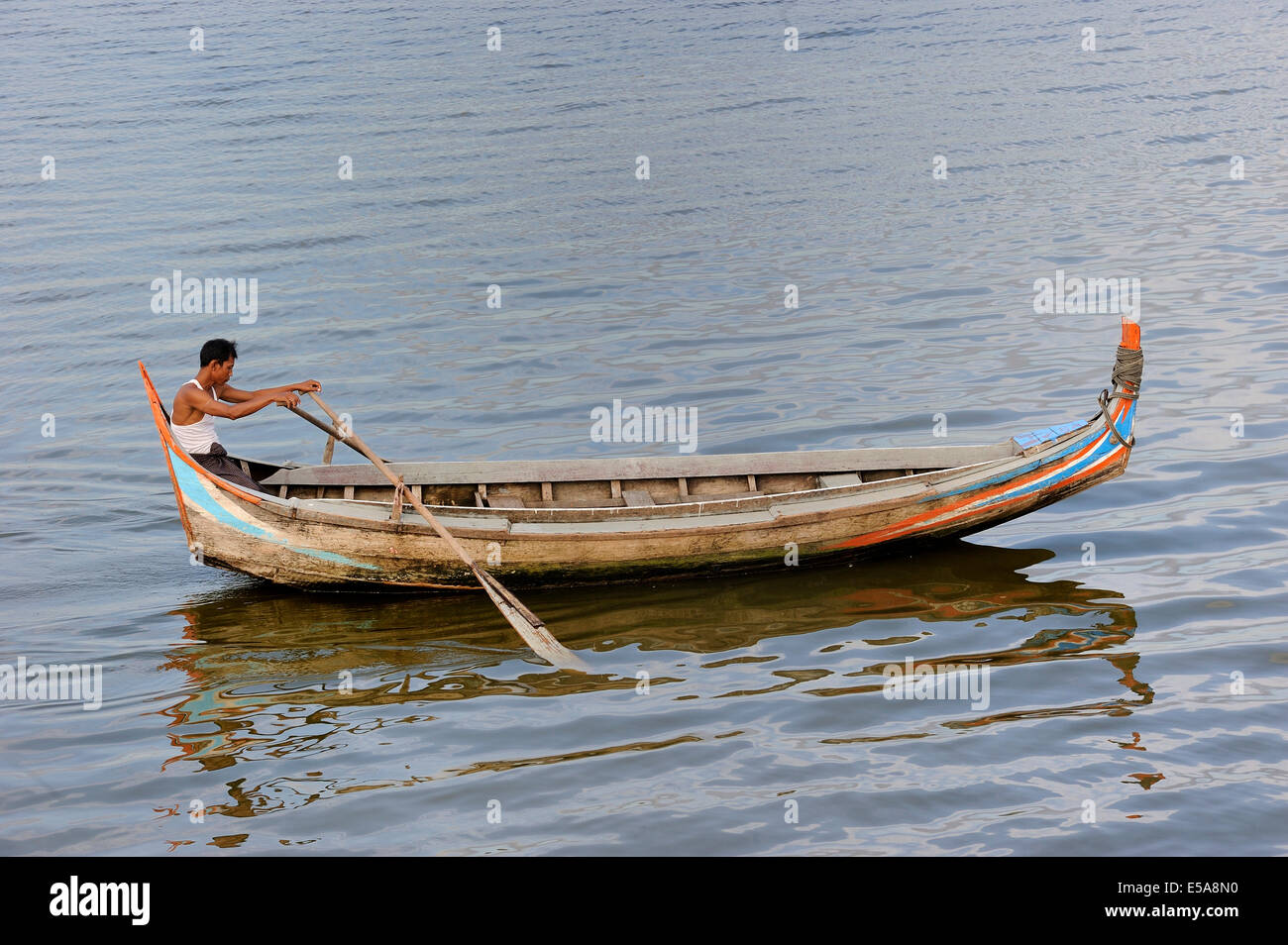 Man in a traditional rowing boat on the Taungthaman Lake, Amarapura, Mandalay Division, Myanmar Stock Photo