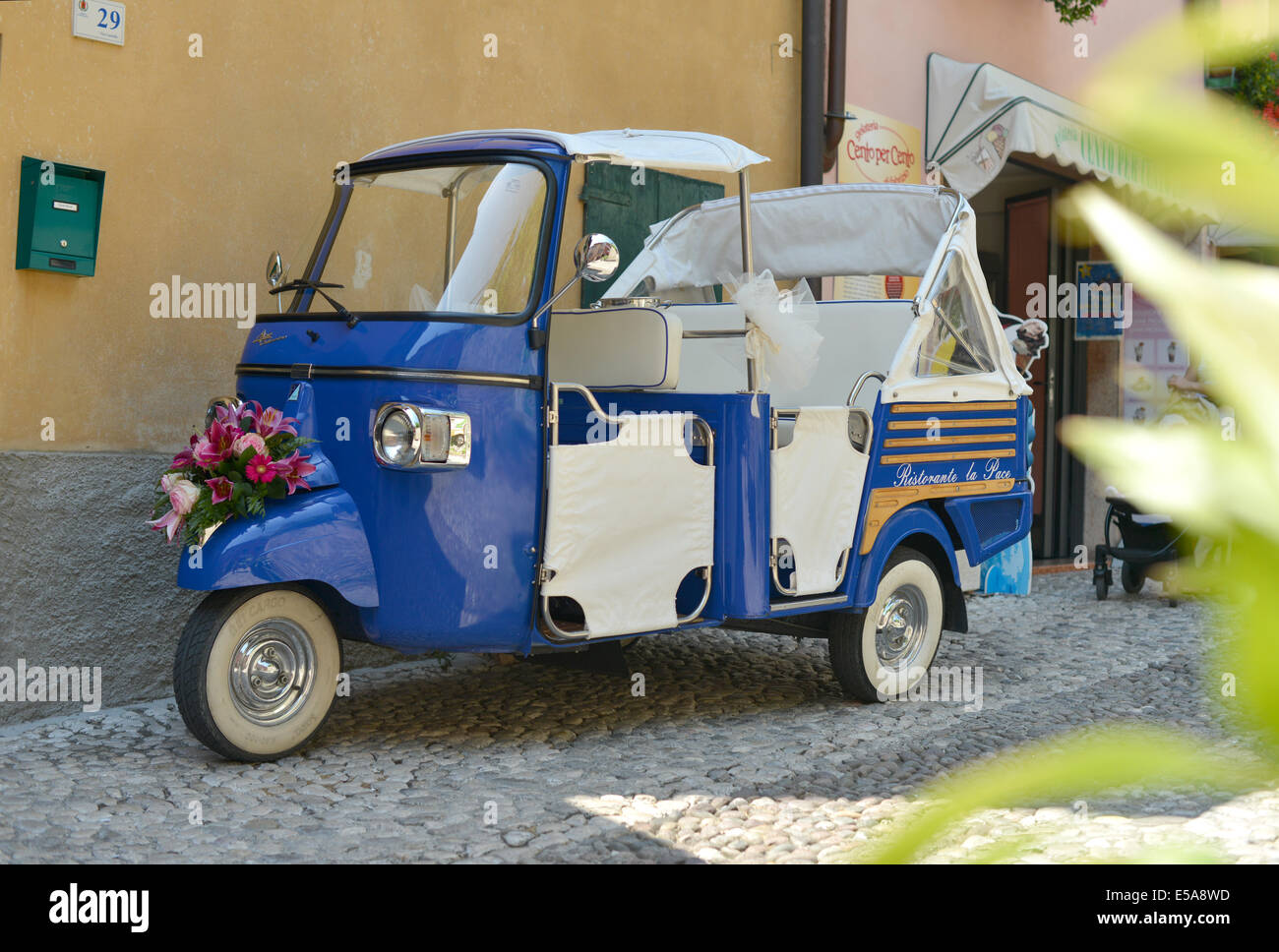Piaggio Ape three wheel micro truck, dressed as a wedding car in Italy, Malcesine, Lake Garda Stock Photo