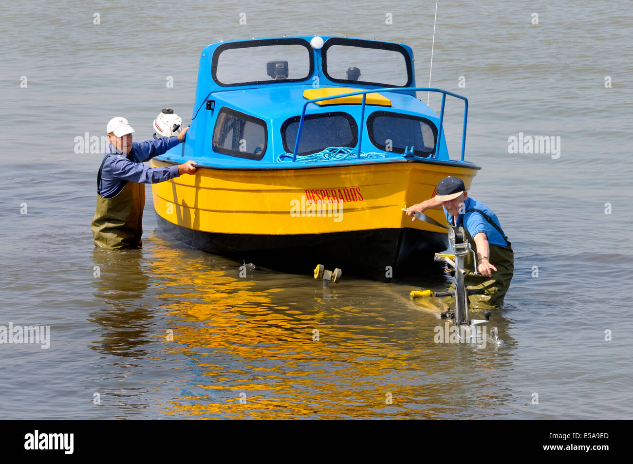 Margate, Kent, England, UK. Two men winching a small boat onto a