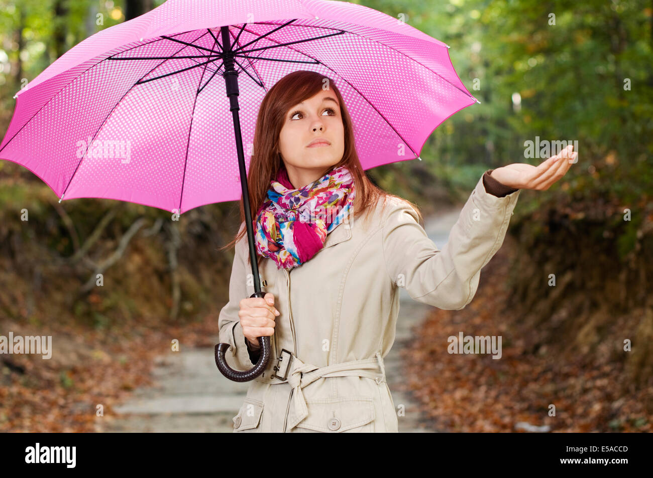 Beautiful girl with umbrella checking for rain, Debica, Poland. Stock Photo