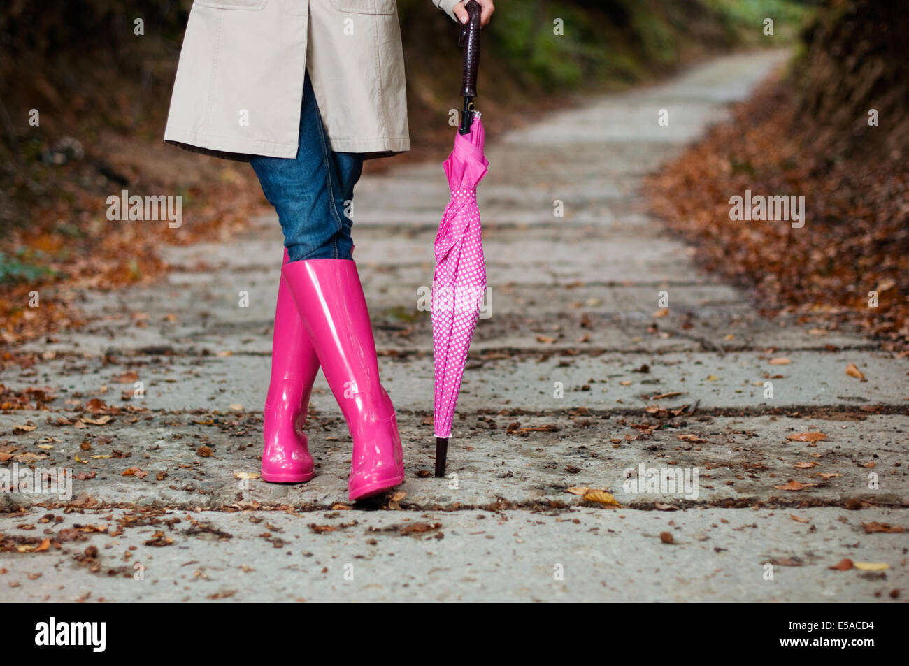 Woman with umbrella wearing rubber boots, Debica, Poland. Stock Photo