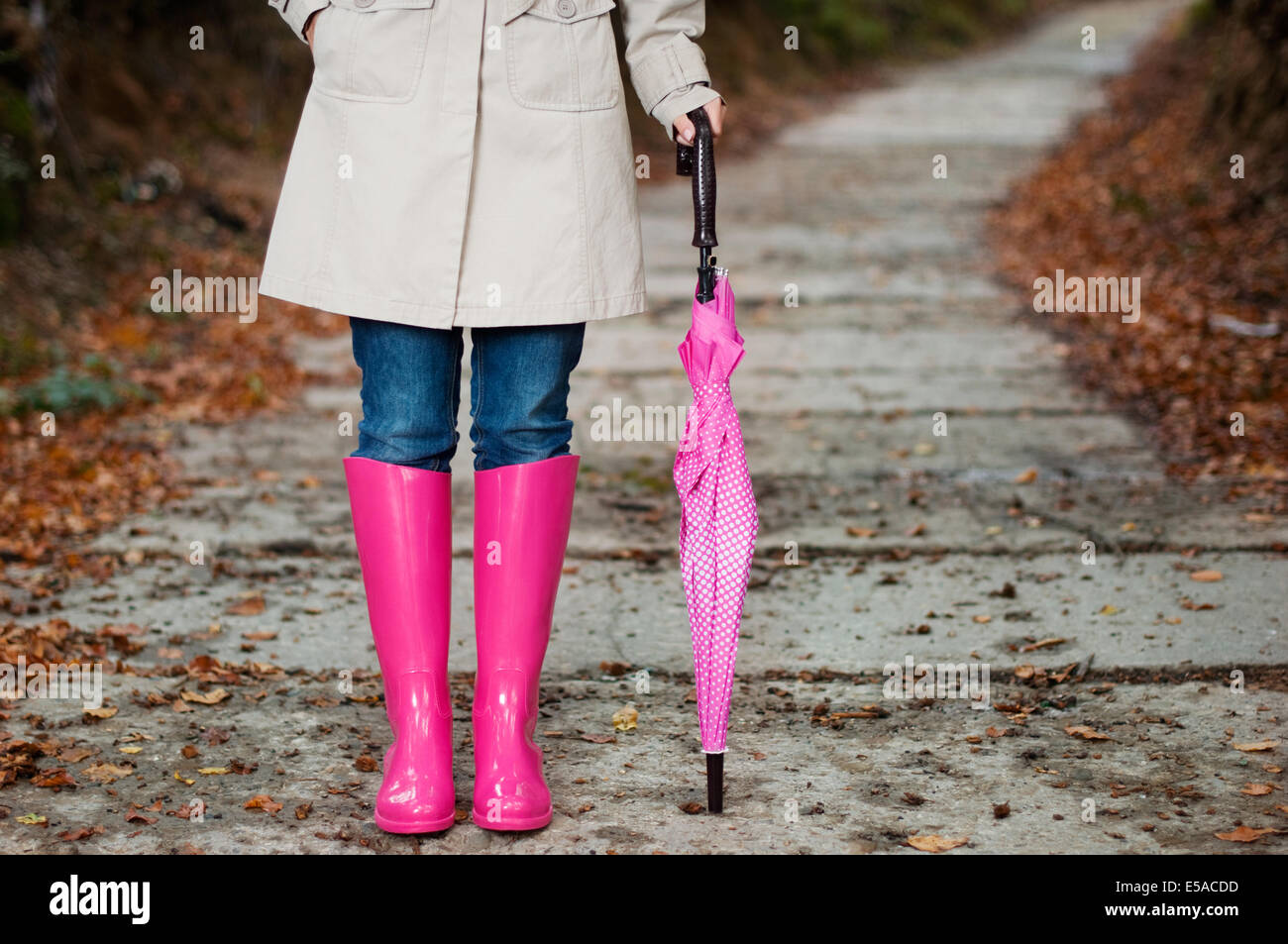 Woman with umbrella wearing rubber boots, Debica, Poland. Stock Photo