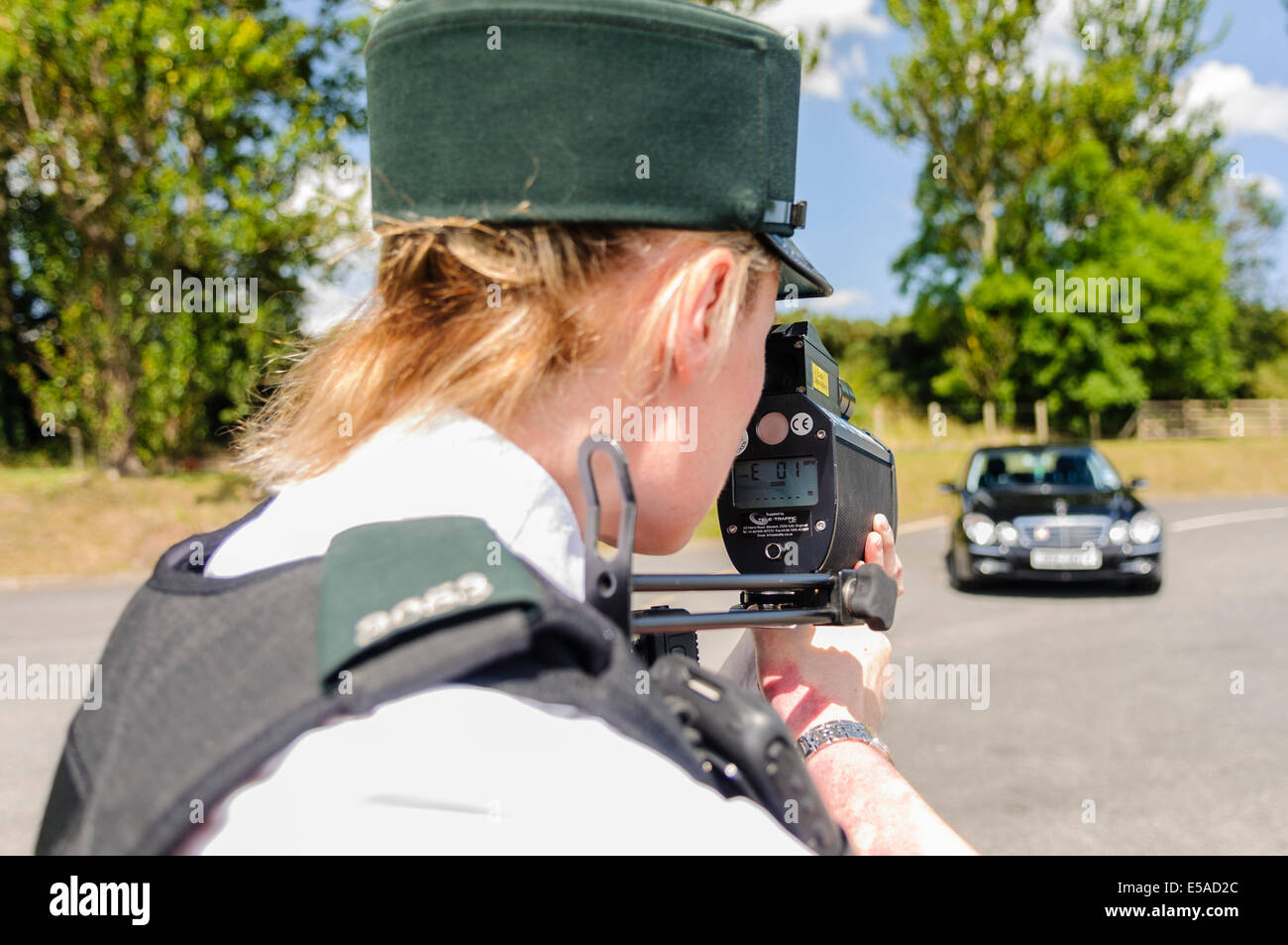 Lisburn, Northern Ireland. 25th July, 2014. - A female police officer uses a laser speed detection gun. Credit:  Stephen Barnes/Alamy Live News Stock Photo