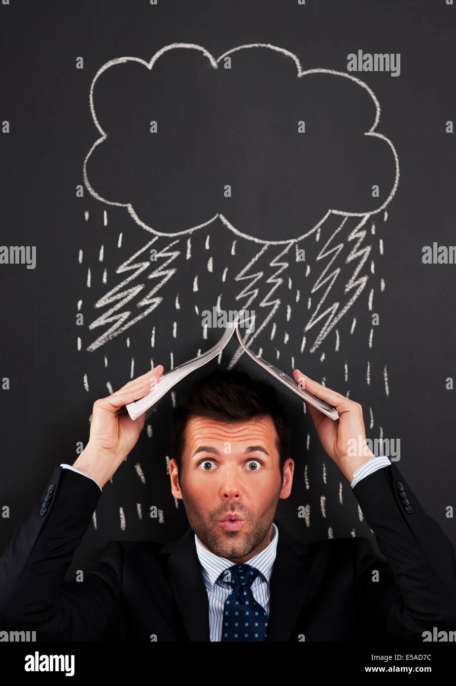 Businessman covering head from rain, Debica, Poland Stock Photo