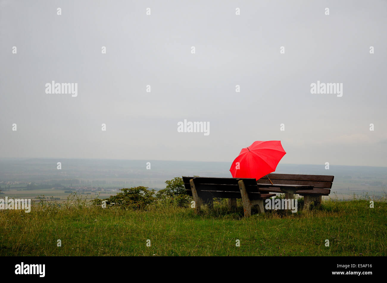 Red umbrella on a picnic area at autumnal weather Stock Photo