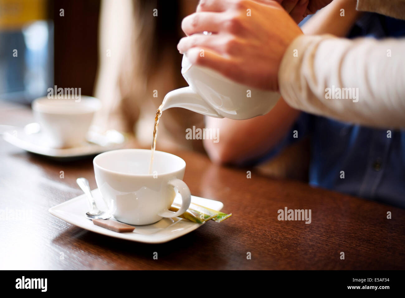 Waitress pouring cup of coffee, Debica, Poland Stock Photo