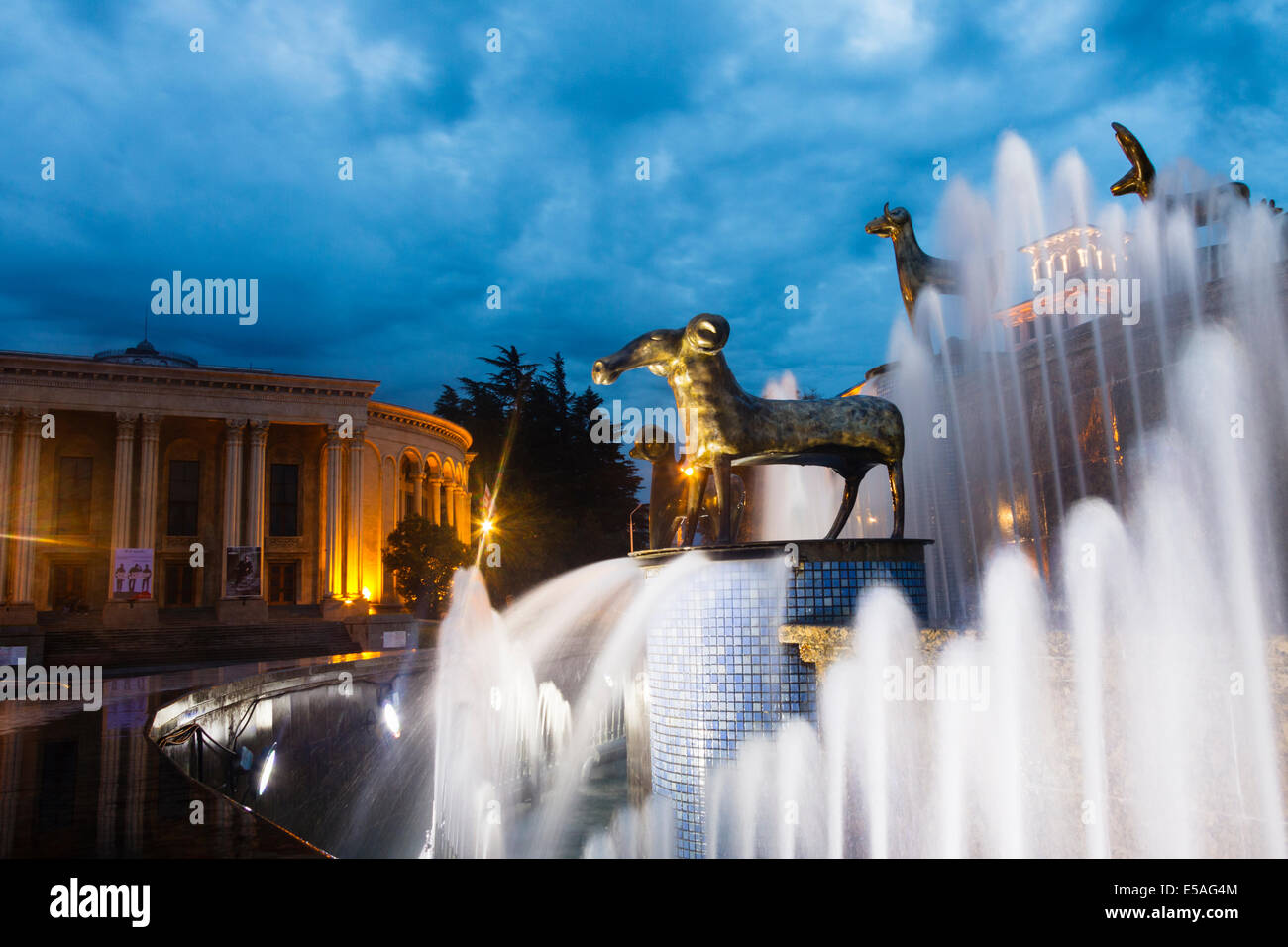 Illuminaed fountain with Golden Fleece statue and Theatre of Drama in background. Kutaisi, Georgia Stock Photo
