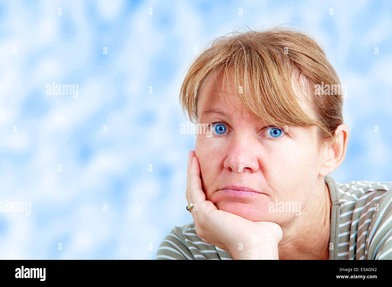 Bored woman looking into the camera Stock Photo