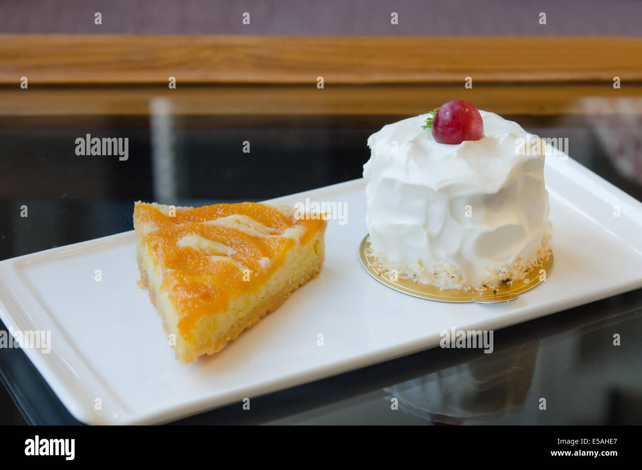 young coconut cake and peach tart on dish Stock Photo