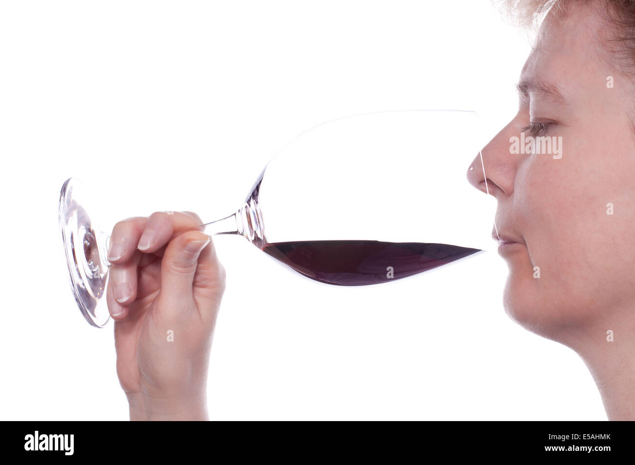 A woman is drinking a glass of red wine Stock Photo - Alamy