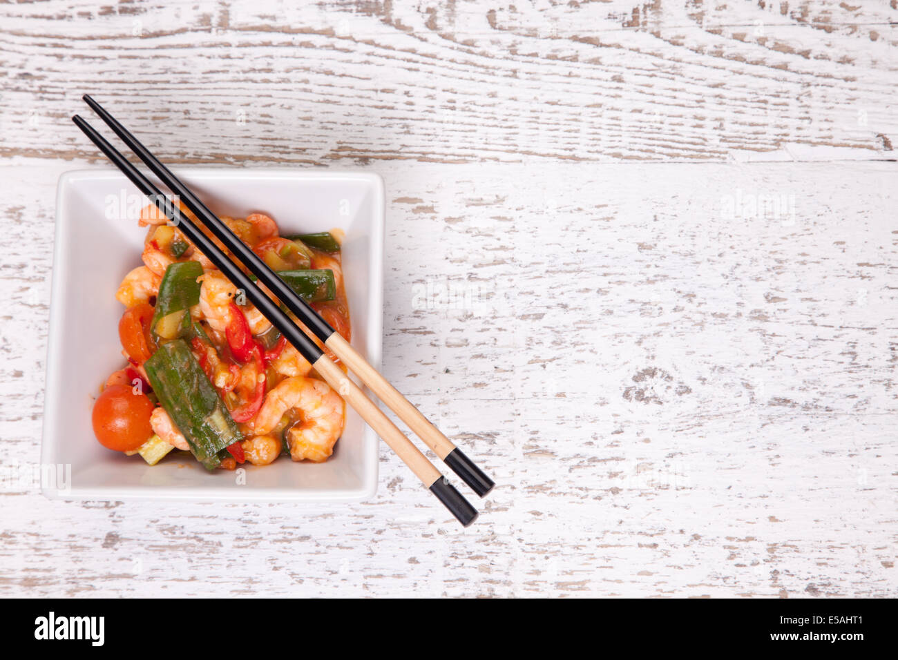 chilli prawns with tomatoes and spring onions Stock Photo