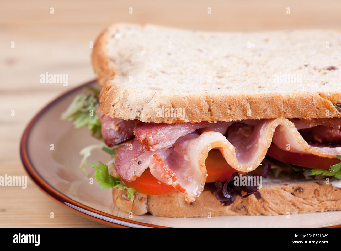 bacon sandwich on brown plate Stock Photo Alamy