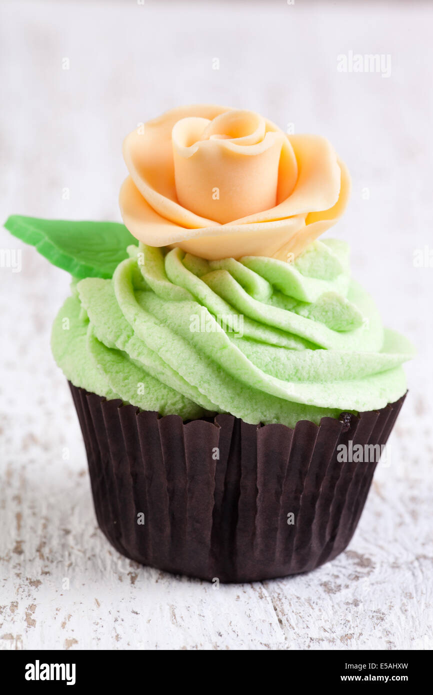 cupcake decorated wit ivory rose Stock Photo